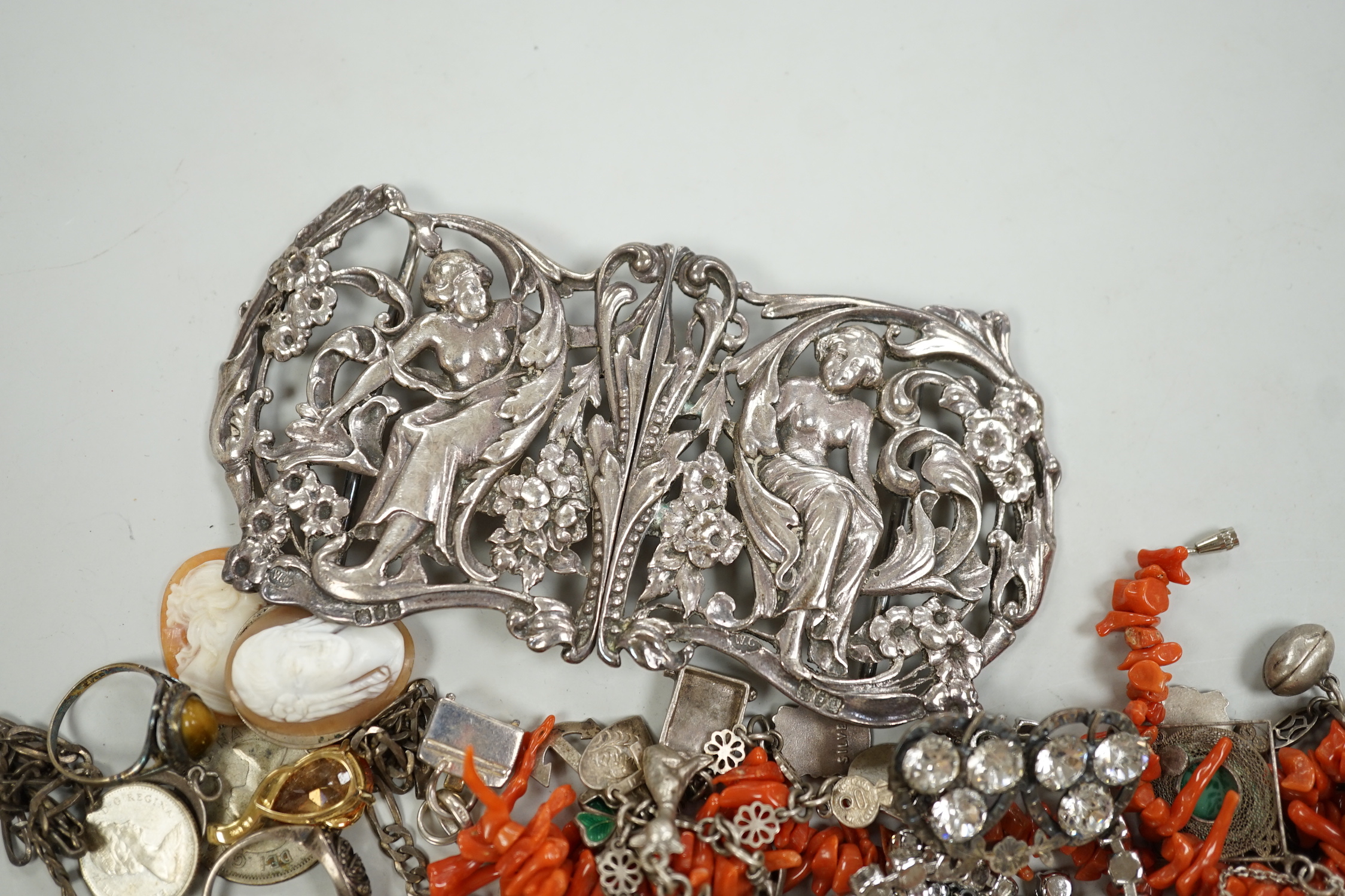 A late Victorian Art Nouveau silver nurses' buckle, William Comyns, London, 1900, 11.9cm and a small group of sundry jewellery including charm bracelet, coral necklace etc.